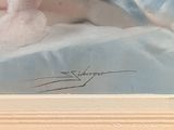 a painting of a dog laying on a bed