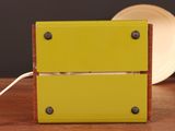 a small yellow box with two drawers on top of it