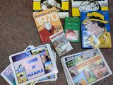 several children ' s books on the floor with pictures of them