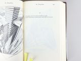 an open book with a drawing of a city on it
