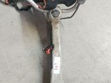 an image of a corded string trimmer in a garage