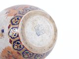 a close up of a vase on a white surface