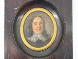 portrait d'un homme vêtu d'un manteau noir et d'un col blanc, dans un cadre en bois