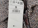 the label on the jacket is attached to the collar of the jacket