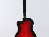 a red guitar hanging from a white wall
