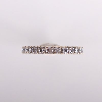 a close up of a diamond ring on a white background