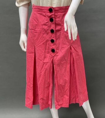 a mannequin wearing a pink skirt with buttons on it