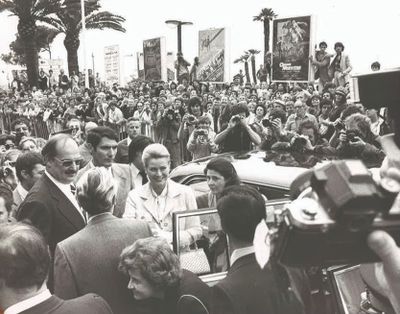 photo en noir et blanc montrant une foule et un homme dans une voiture