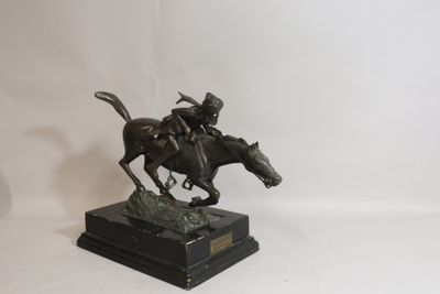 statue of a man riding a horse on a black base