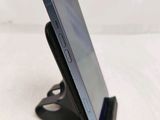 a cell phone that is on a stand on a table