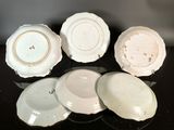several plates are arranged on a table with a black background