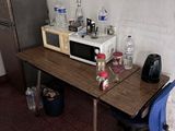 une petite table sur laquelle est posé un micro-ondes