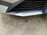a close up of a car ' s grille with a blue sticker on it