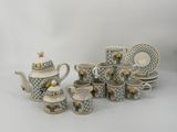 many different types of teapots and cups on the table
