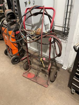 a cart with a hose attached to it in a garage