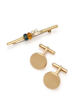 two pairs of gold tone cufflinks and a beaded tie bar