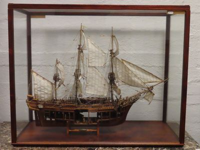 a small model of a ship in a glass case