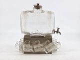 an old fashioned glass beverage dispenser with a faucet on it