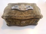a small stone box with a metal handle on a table