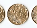 three coins are shown on a white surface, one has a woman and the other has a man