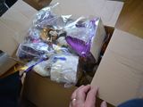 a person holding a box full of stuffed animals