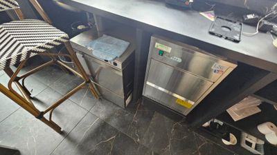 a kitchen with a counter and two stools in it