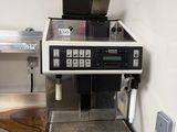 a coffee machine sitting on top of a stainless steel counter