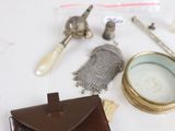 a wallet, a watch, and a pair of scissors on a table