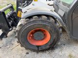 a tractor that is parked on the side of the road