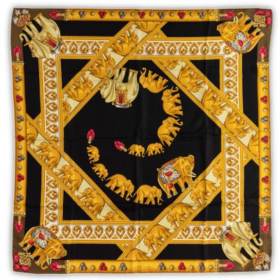 a black and gold scarf with elephants and flowers on it