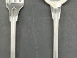two spoons and a fork sitting on a table
