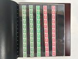 a black binder with a bunch of green and red stickers on it