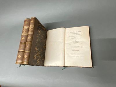un livre ouvert posé sur une table près d'un mur
