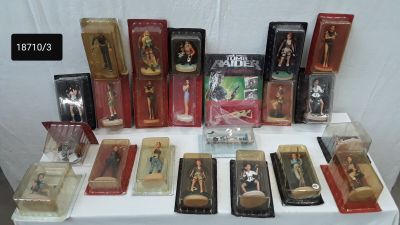 many different types of figurines displayed on a table