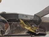 a close up of a gun with a knife in it