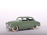 a green toy car that is sitting on a white surface