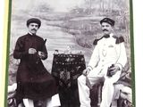an old photo of two men in uniform sitting next to each other