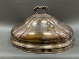 a silver plate with a lid on a table