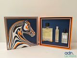 une boîte orange et noire contenant deux flacons de parfum et une boîte orange et noire contenant deux flacons de parfum