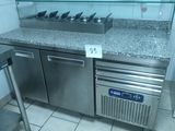 a stainless steel counter top with a glass shelf above it