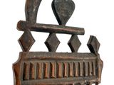 a wooden comb with a heart on top of it