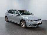 a silver volkswagen golf is parked in a white room