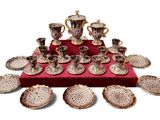 a picture of a table with a lot of cups and saucers