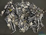a pile of black and white lanyards on a table