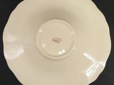 a close up of a white plate on a black surface