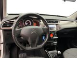the interior of a car with a steering wheel and dashboard controls