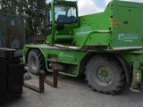 a large green truck that is parked in the parking lot