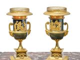 two vases sitting on a marble table with a white background