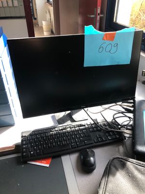 a computer on a desk with a keyboard and mouse