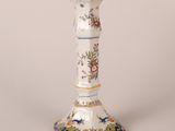 a white and blue vase sitting on a table